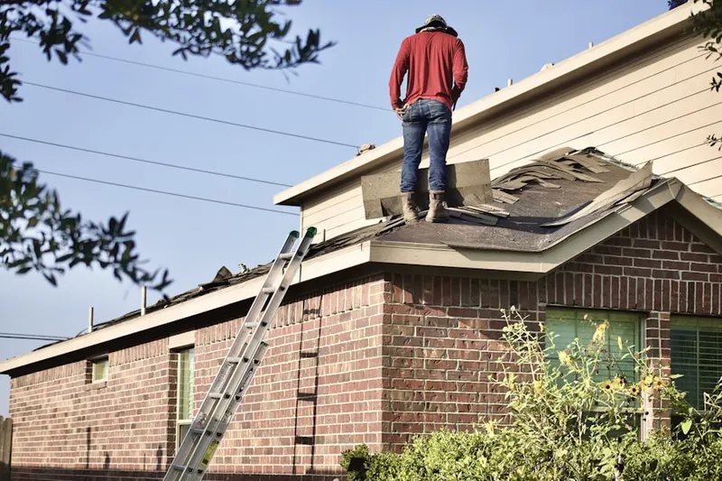 Professional roofer working on a residential roof in Goulds